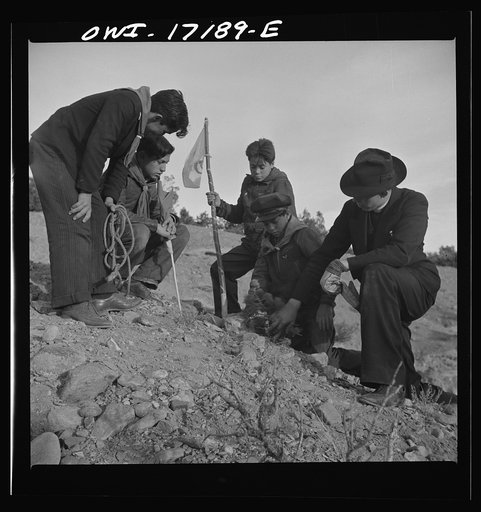 Untitled photo, possibly related to: Taos County, New Mexico. Father Cassidy, the Catholic priest of the parish of Penasco, telling his troop of Boy Scouts about the science of geology