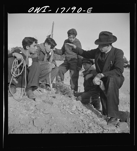 Untitled photo, possibly related to: Taos County, New Mexico. Father Cassidy, the Catholic priest of the parish of Penasco, telling his troop of Boy Scouts about the science of geology