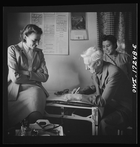 Penasco, New Mexico. Doctor Onstine, medical doctor, writing a prescription in the clinic operated by the Taos County cooperative health association