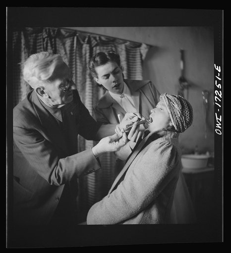 Untitled photo, possibly related to: Penasco, New Mexico. Doctor Onstine, medical doctor, making an examination in the clinic operated by the Taos County cooperative health association