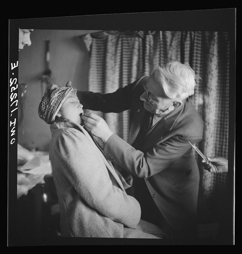 Untitled photo, possibly related to: Penasco, New Mexico. Doctor Onstine, medical doctor, making an examination in the clinic operated by the Taos County cooperative health association