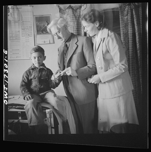 Untitled photo, possibly related to: Penasco, New Mexico. Doctor Onstine, medical doctor, making an examination in the clinic operated by the Taos County cooperative health association