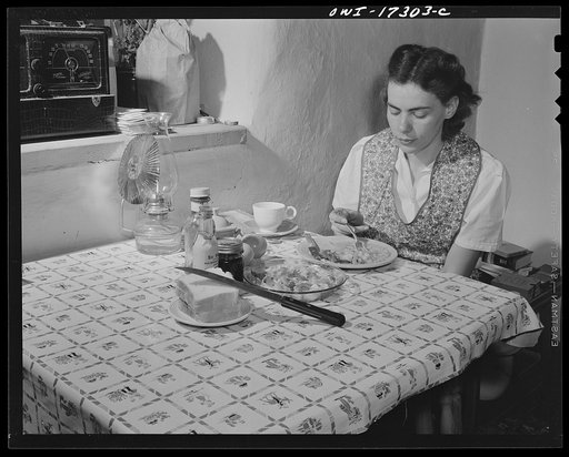 Penasco, New Mexico. Marjorie Muller, resident nurse at the clinic operated by the Taos County cooperative health association, does her own cooking in her one-room home