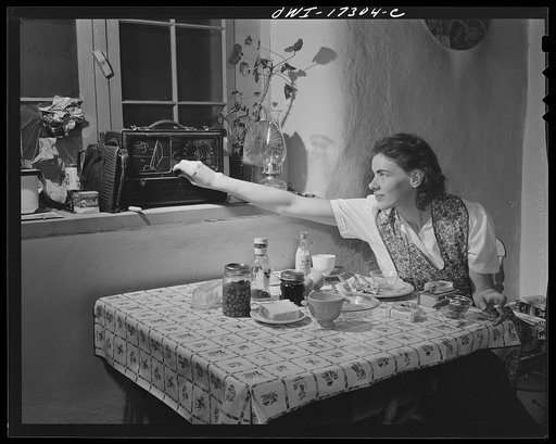 Penasco, New Mexico. The radio is the only contact with the outside world. Papers come rarely to the town, and the nurse at the clinic operated by the Taos County cooperative health association must depend on the news broadcasts to follow daily events