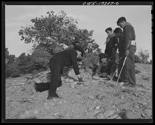 Untitled photo, possibly related to: Penasco, New Mexico. Father Cassidy instructing his Boy Scout troop in geology