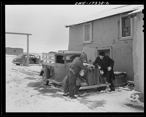 Taos County, New Mexico. Father Cassidy, the Catholic priest of the parish of Penasco, helping to appraise the value of the farm and equipment of a parishioner who wants to borrow money to purchase the farm