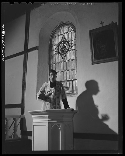 Taos County, New Mexico. Father Cassidy, the Catholic priest of the parish of Penasco, delivering a sermon