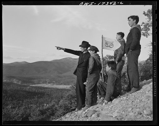 Taos County, New Mexico. Father Cassidy, the Catholic priest of the parish of Penasco, in the mountains with his troop of Boy Scouts. He is the scout master of Penasco