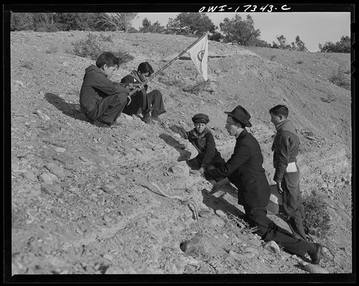 Untitled photo, possibly related to: Taos County, New Mexico. Father Cassidy, the Catholic priest of the parish of Penasco, telling his troop of Boy Scouts about the science of geology