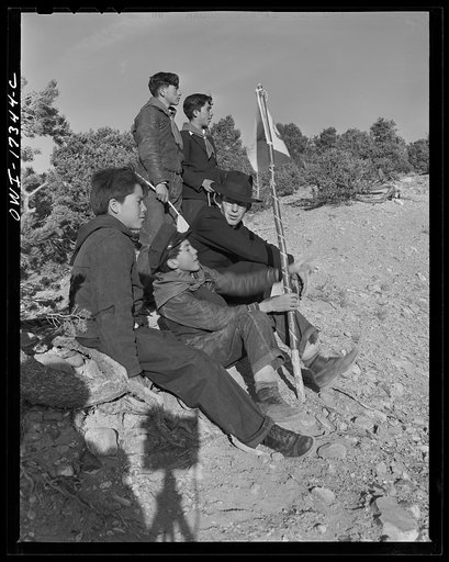 Untitled photo, possibly related to: Taos County, New Mexico. Father Cassidy, the Catholic priest of the parish of Penasco, telling his troop of Boy Scouts about the science of geology