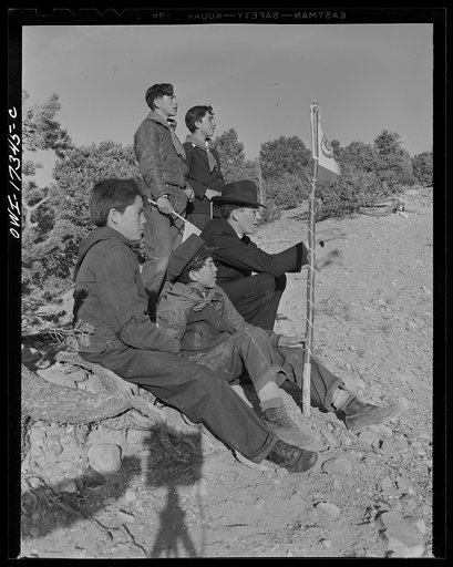 Untitled photo, possibly related to: Taos County, New Mexico. Father Cassidy, the Catholic priest of the parish of Penasco, telling his troop of Boy Scouts about the science of geology