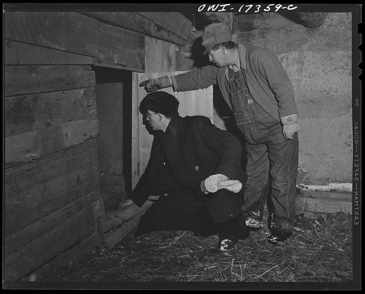 Taos County, New Mexico. Father Cassidy, the Catholic priest of the parish of Penasco, inspecting a parishioner's property so he may be able to advice him