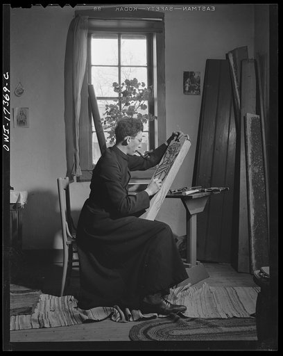 Taos County, New Mexico. Father Cassidy, the Catholic priest of the parish of Penasco, woodcarving