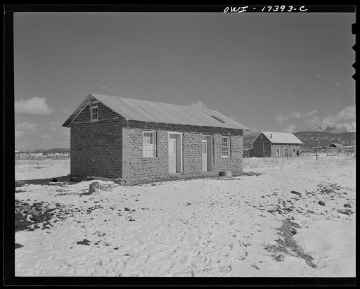 Penasco, Taos County, New Mexico. Modern homes are built smaller, for there are no longer time and materials in abundance. People must do migratory labor for cash, in order to live and to purchase tin for roofs, lumber for sashes and doors