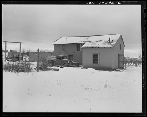 Taos County, New Mexico. Father Cassidy, the Catholic priest of the parish of Penasco, arriving at the home of a poor parishioner who has turned to the priest for business advice