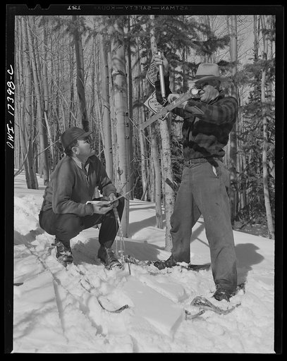 U.S. forest rangers in the Sangre de Cristo Mountains above Penasco, New Mexico, weighing snow to predict the amount of irrigation for the coming year
