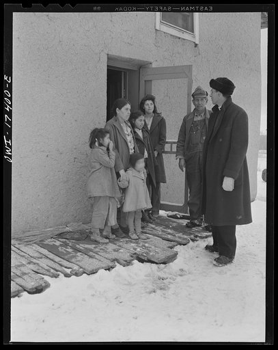 Untitled photo, possibly related to: Taos County, New Mexico. Father Cassidy, the Catholic priest of Penasco, smoking and talking things over with a parishoner