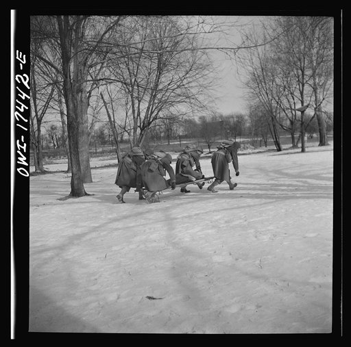 Carlisle, Pennsylvania. Demonstration before Army doctors and officer candidates at the U.S. Army medical field service school. Close behind company aid men at the front line come the litter bearers to carry "wounded" soldiers back to battalion aid stations some 500 yards behind the lines. The litte