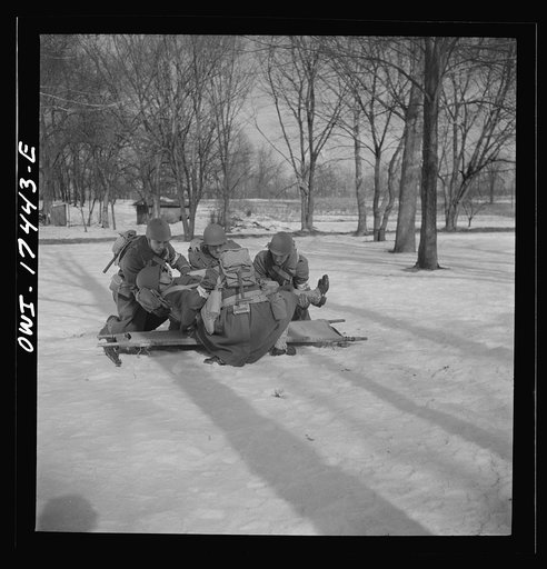 Carlisle, Pennsylvania. Demonstration before Army doctors and officer candidates at the U.S. Army medical field service school. Close behind company aid men at the front line come the litter bearers to carry "wounded" soldiers back to battalion aid stations some 500 yards behind the lines. The litte