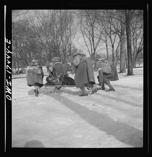 Carlisle, Pennsylvania. Demonstration before Army doctors and officer candidates at the U.S. Army medical field service school. Close behind company aid men at the front line come the litter bearers to carry "wounded" soldiers back to battalion aid stations some 500 yards behind the lines. The litte