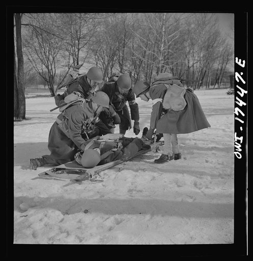Carlisle, Pennsylvania. Demonstration before Army doctors and officer candidates at the U.S. Army medical field service school. Placing a "wounded" man on a litter