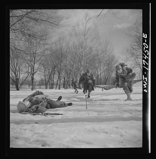 Carlisle, Pennsylvania. Demonstration before Army doctors and officer candidates at the U.S. Army medical field service school. Three company aid men, (i.e., unarmed medical soldiers), are attached to each infantry company as well as other fighting units, and move with them into thick of battle. Whe