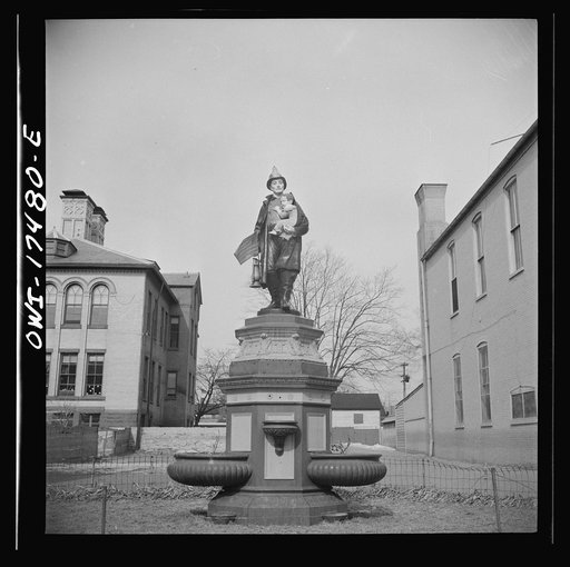 Carlisle, Pennsylvania. Polychrome statue of a fireman rescuing a child outside the firehouse