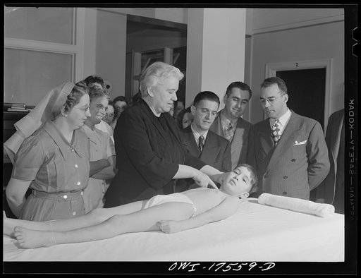 Minneapolis, Minnesota. Sister Kenny conducting a class at the Elizabeth Kenny Institute. On her left are Dr. Pedro Gonzales of Havana, Cuba and Dr. James Vila of San Juan, Puerto Rico. The patient is Felix Serralles of Puerto Rico, whose father is employed on a sugar plantation near Ponce. Felix ha