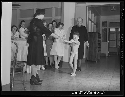 Minneapolis, Minnesota. Marvin Goldstein, five and a half years old, was seriously stricken with infantile paralysis when admitted to the Elizabeth Kenny Institute in September 17th, 1942. His neck, spine and legs were affected. He was discharged five months later. Here he demonstrates for student t