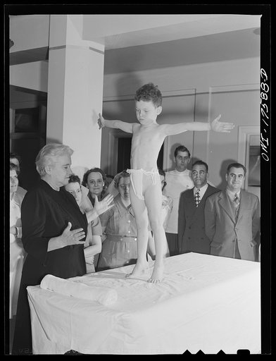 Minneapolis, Minnesota. Marvin Goldstein, an infantile paralysis patient, showing ability to stant on his toes, at a class for technicians and doctors being conducted by Sister Kenny
