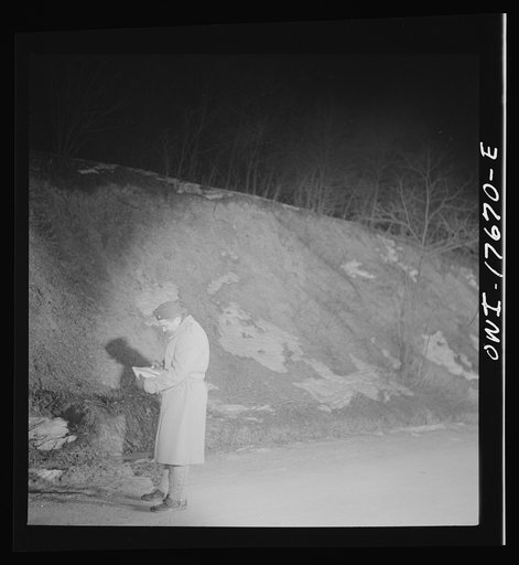 Carlisle, Pennsylvania. U.S. Army medical field service school. Army doctor starting out on a night problem. Students are left alone in unknown spot with map, flashlight, and compass, and instructed to find their way to a certain place