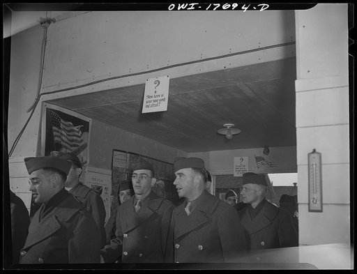 Carlisle, Pennsylvania. Medical field service training school. Officer candidates who are learning to be medical administrative officers entering a lecture hall. Printed signs have been placed there to remind them that they are to have a night problem during which they will be left alone in the dark