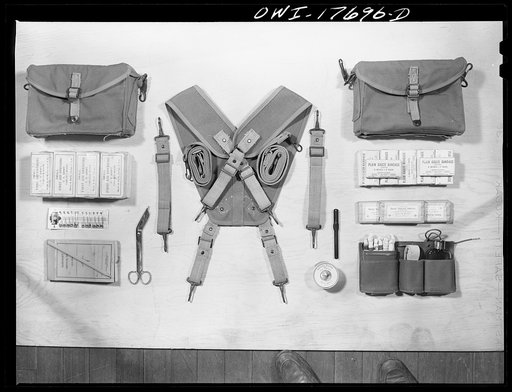 Carlisle, Pennsylvania. Medical field service training school. Contents of a medical soldier's pouches which are carried on each side by straps: different types of bandages, safety pins, emergency medical tags for identification of wounded, scissors, adhesive tape, thermometer, iodine swabs, tourniq