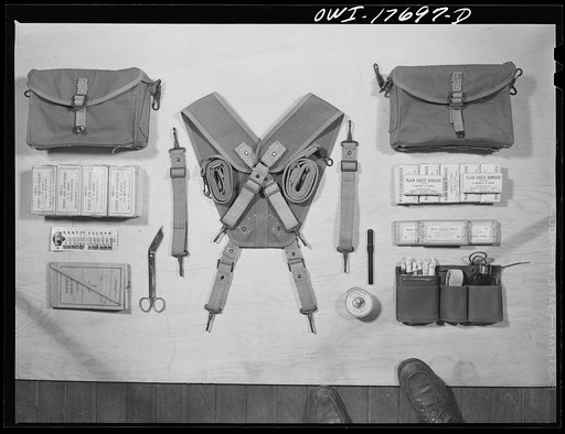 Untitled photo, possibly related to: Carlisle, Pennsylvania. Medical field service training school. Contents of a medical soldier's pouches which are carried on each side by straps: different types of bandages, safety pins, emergency medical tags for identification of wounded, scissors, adhesive tap