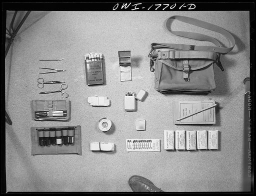 Untitled photo, possibly related to: Carlisle, Pennsylvania. Medical field service training school. Contents of the kit carried by a medical officer: surgical kit and instruments, iodine swabs, sterilizer, pill boxes, hypodermic case, diagnosis tags, adhesive tape, hypodermic needles, medicinal vial