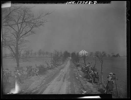 Untitled photo, possibly related to: Carlisle, Pennsylvania. Medical field service training school. During the practice road march, United States Army doctors are surprised by an "enemy plane," and start to disperse to the side of the road.