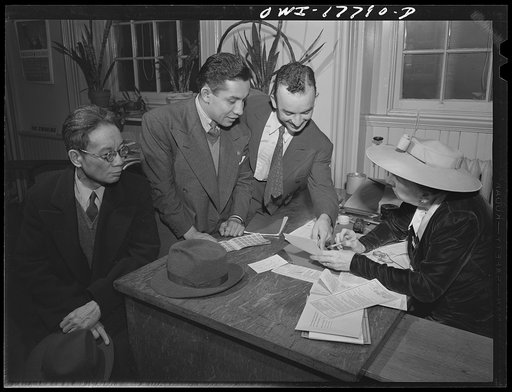 Washington, D.C. A Chinaman and two South Americans registering for the second ration books at a public school on the corner of Tenth and F Streets