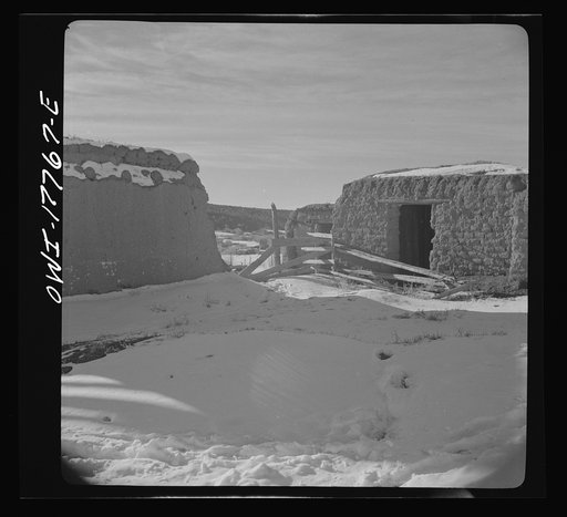 Trampas, Taos County, New Mexico. Deserted houses in a Spanish-American village in the foothills of the Sangre de Cristo Mountains. Once water eats in between the bricks, adobe houses crumble away quickly