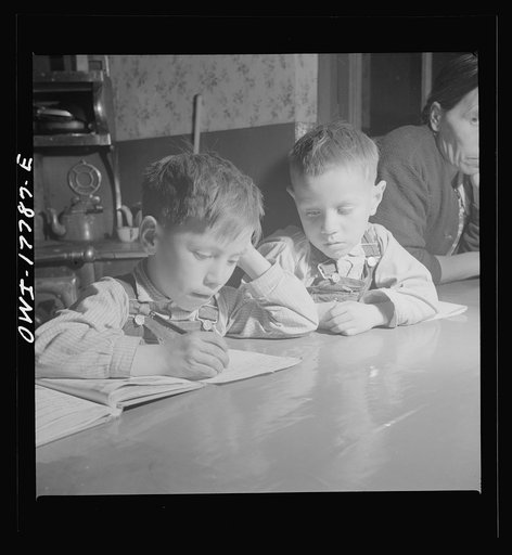 Trampas, New Mexico. The Lopez children doing their homework on the kitchen table