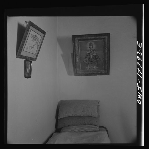 Trampas, New Mexico. Grade school diploma of Cora Romero and prints on the wall of one of the bedrooms of Juan Lopez, the majordomo [i.e., steward