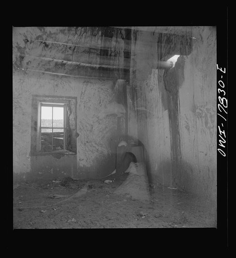 Untitled photo, possibly related to: Trampas, Taos County, New Mexico. A deserted adobe in a Spanish-American village in the foothills of the Sangre de Cristo Mountains. This fireplace was used for cooking and heating