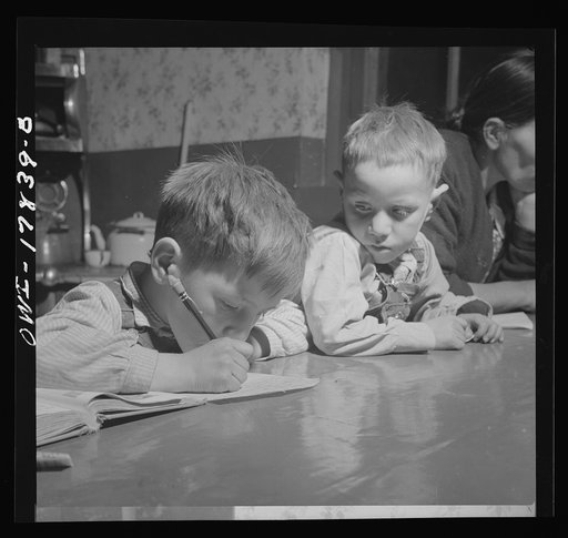 Trampas, New Mexico. The Lopez children doing their homework on the kitchen table