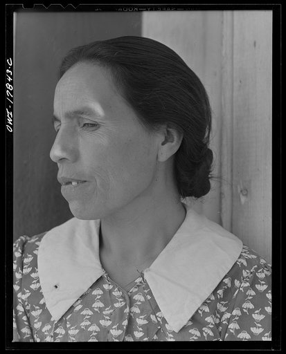 Untitled photo, possibly related to: Trampas, New Mexico. Maclovia Lopez, wife of the majordomo (mayor) [i.e., steward], spinning wool by the light of the fire. The family has ten sheep and they spin the wool for blankets, which are woven for them in Cordova