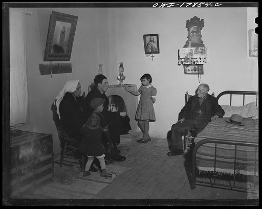 Taos County, New Mexico. Father Cassidy, the Catholic priest of the parish of Penasco, advising his parishioners