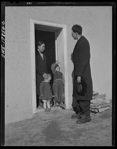 Taos County, New Mexico. Father Cassidy, the Catholic priest of the parish of Penasco, visiting Juan Lopez, a parishioner in Trampas