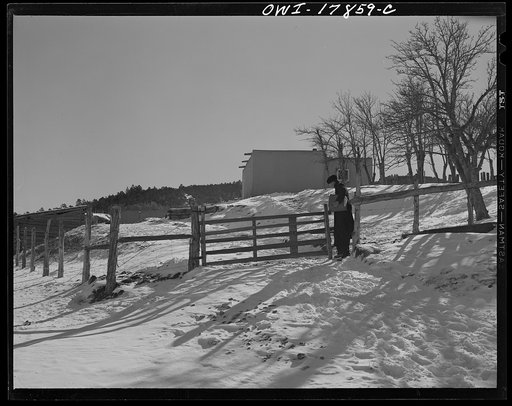 Taos County, New Mexico. Father Cassidy, the Catholic priest of the parish of Penasco, visiting Juan Lopez, a parishioner in Trampas