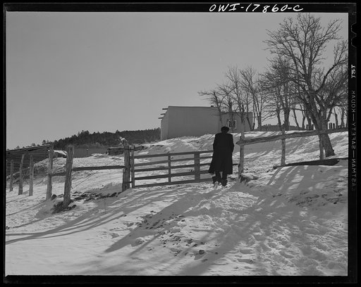 Untitled photo, possibly related to: Taos County, New Mexico. Father Cassidy, the Catholic priest of the parish of Penasco, visiting Juan Lopez, a parishioner in Trampas