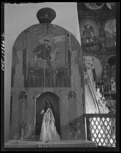 Trampas, New Mexico. The side altar to the left of the nave of a church which was built in 1700, and is the best-preserved colonial mission in the Southwest