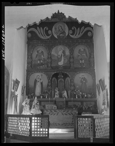 Untitled photo, possibly related to: Trampas, New Mexico. Main altar of painted wood in a church which was built in 1700, and is the best-preserved colonial mission in the Southwest. There is an older altar behind the wooden one which is painted directly on the adobe wall