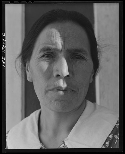 Untitled photo, possibly related to: Trampas, New Mexico. Maclovia Lopez, wife of the majordomo (mayor) [i.e., steward], spinning wool by the light of the fire. The family has ten sheep and they spin the wool for blankets, which are woven for them in Cordova